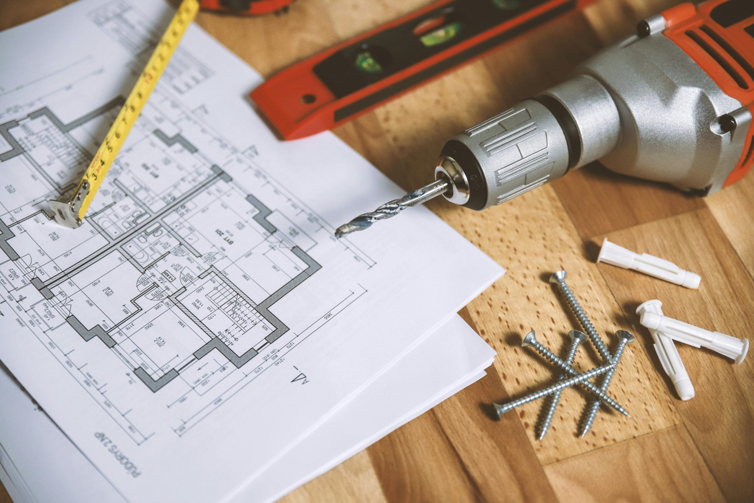 Building blue prints with a drill and pencil showing