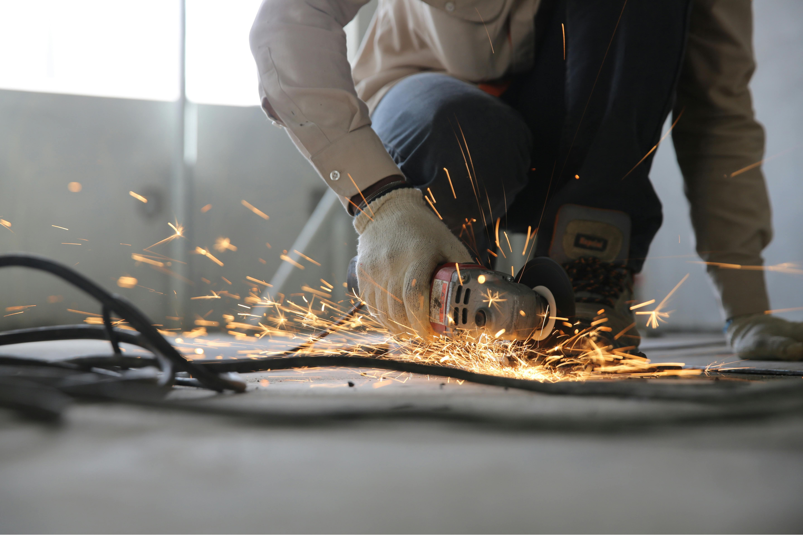 Angle grinder cutting through metal
