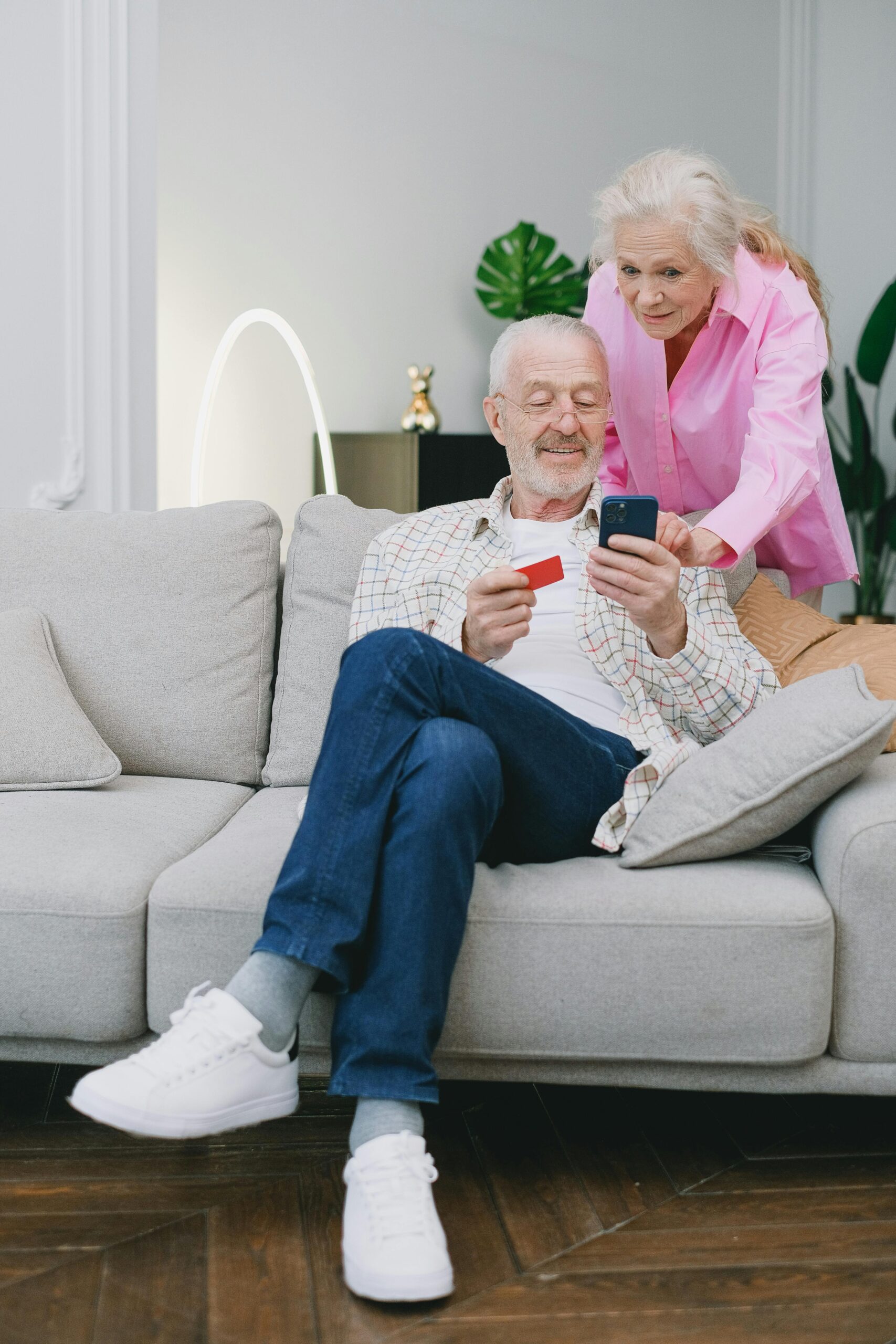 Older couple buying off their laptop